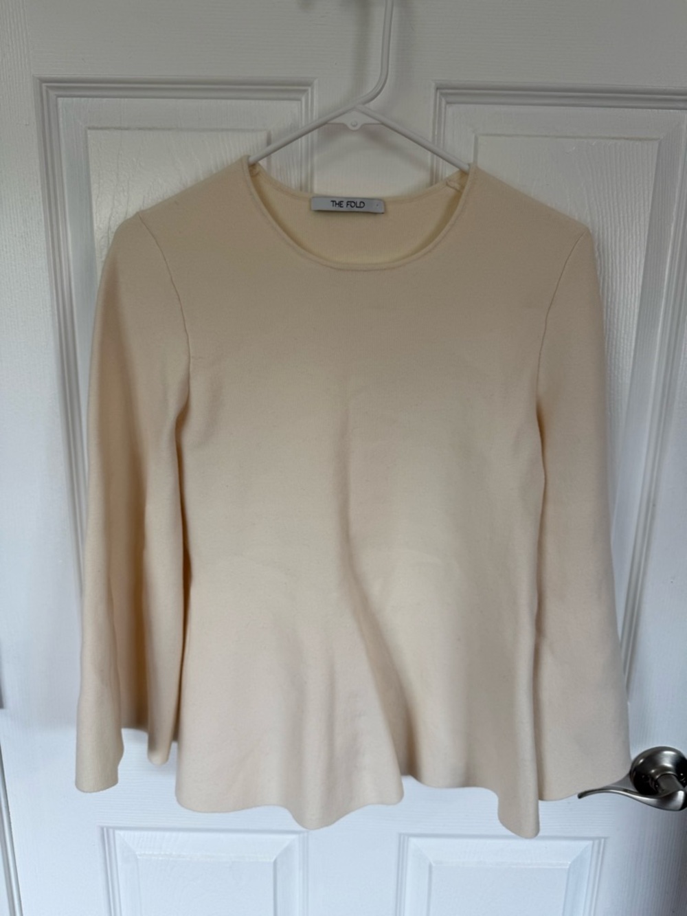 The Fold Cream Long-Sleeve Peplum Knit Top